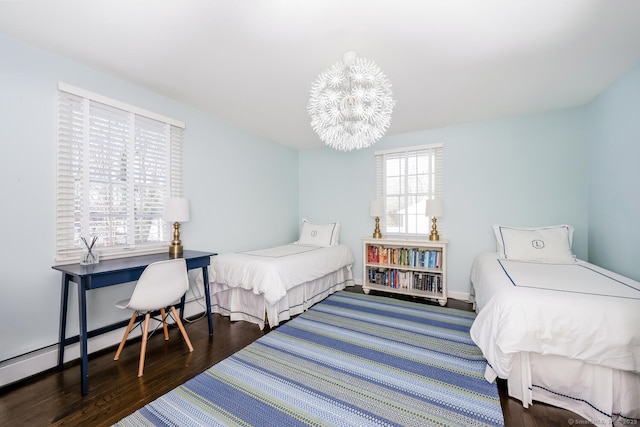 bedroom featuring dark hardwood / wood-style flooring and a chandelier