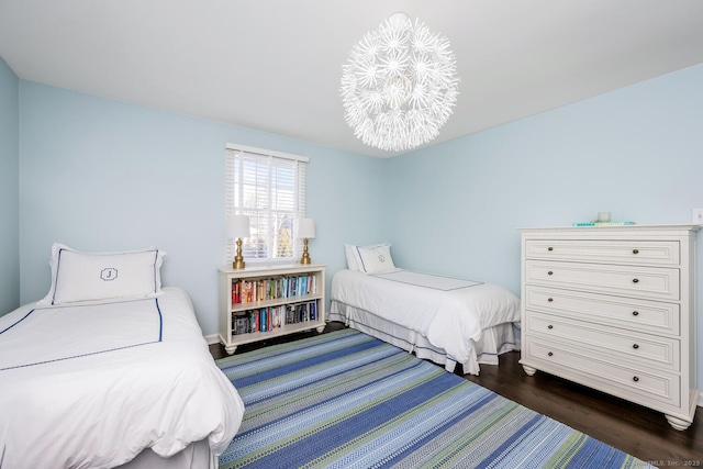 bedroom with a chandelier and dark hardwood / wood-style flooring