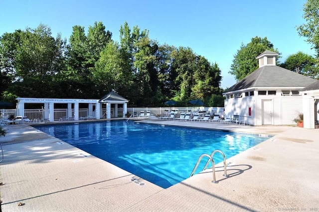 pool with fence and a patio