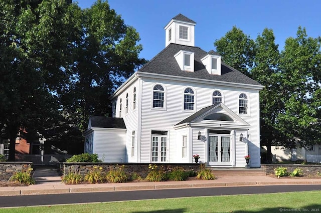 colonial house featuring french doors