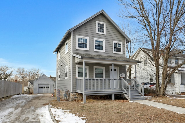 view of front of house featuring a garage, an outdoor structure, and covered porch