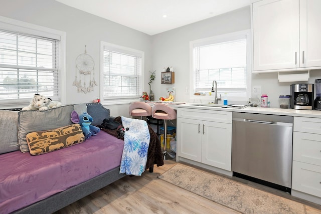 bedroom featuring sink and light hardwood / wood-style floors