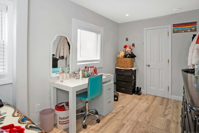 home office with light hardwood / wood-style floors