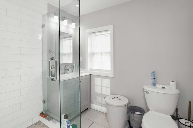 bathroom featuring toilet, sink, tile patterned floors, and a shower with shower door