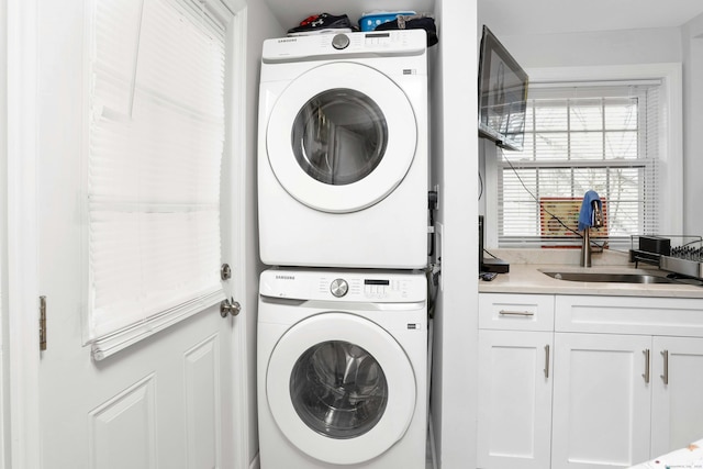 washroom featuring sink and stacked washer and clothes dryer