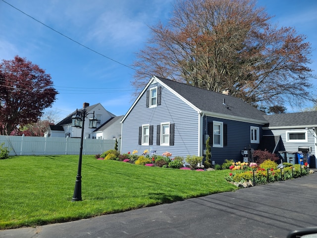 view of property exterior with a lawn