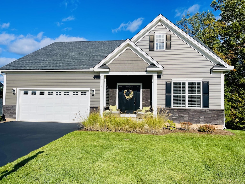 view of front of home featuring a garage and a front yard