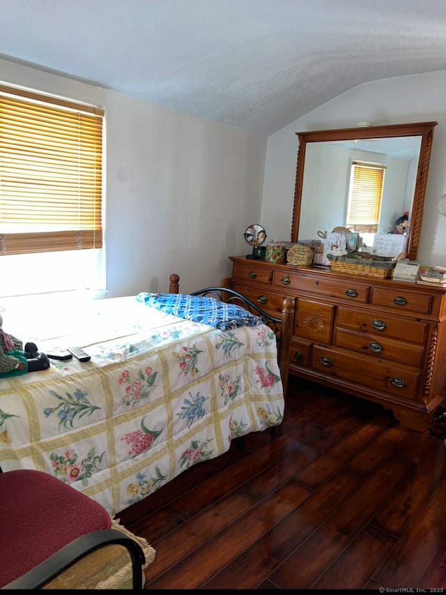 bedroom featuring dark wood-type flooring and lofted ceiling