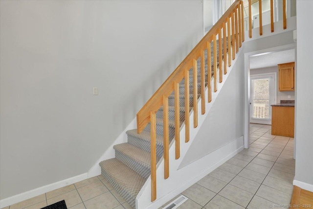 stairway with tile patterned flooring