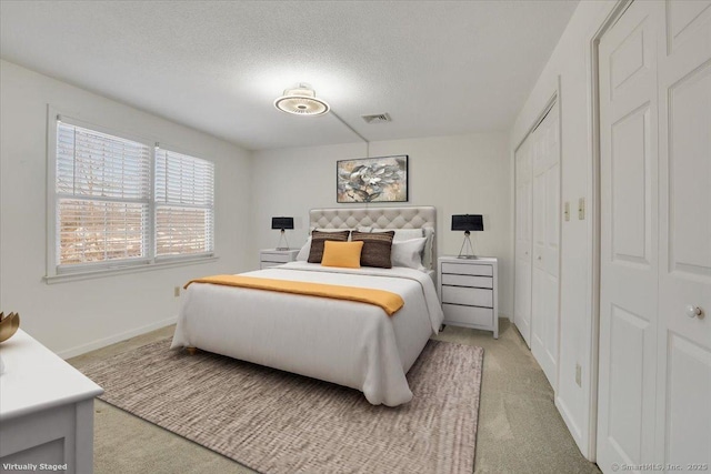 bedroom featuring a textured ceiling and carpet flooring