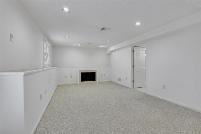 unfurnished living room featuring light colored carpet