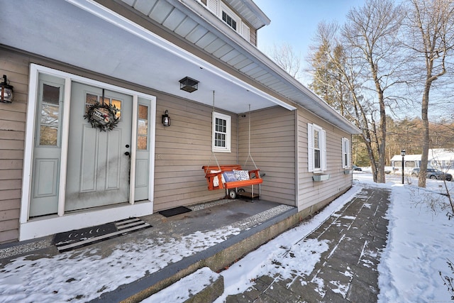 view of snow covered property entrance