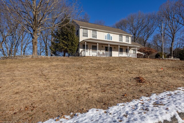 view of front facade featuring a porch and a yard