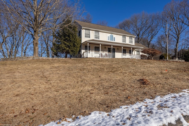 view of front facade featuring a porch and a lawn