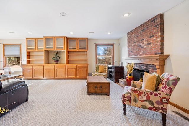 living room featuring light carpet and a fireplace