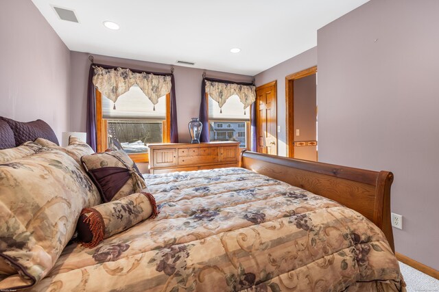 bedroom featuring recessed lighting, carpet flooring, visible vents, and baseboards