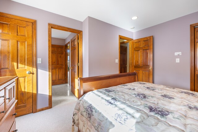 bedroom featuring light carpet, baseboards, and recessed lighting