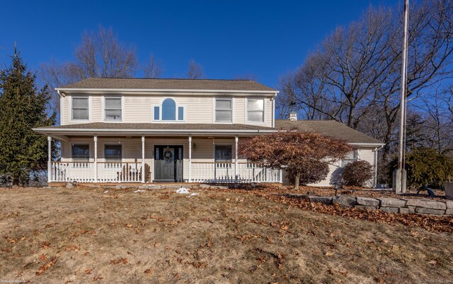 view of front of property with a front yard and a porch