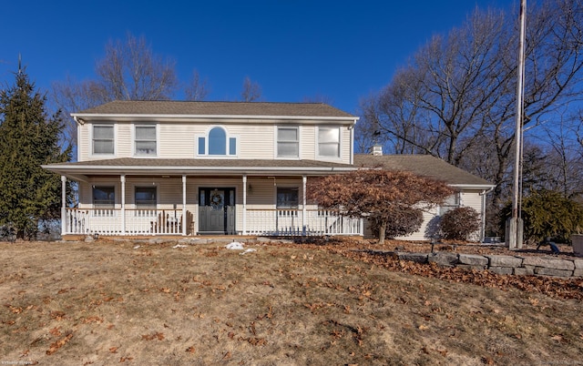 view of front of property featuring a front yard and covered porch