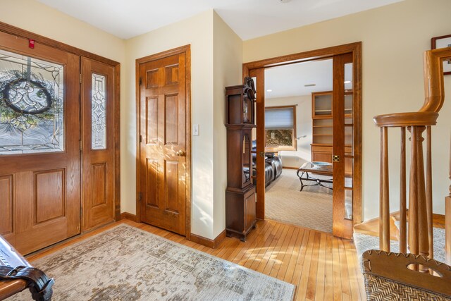 foyer featuring light wood-style flooring and baseboards