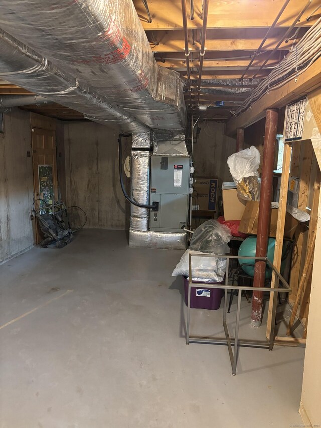 unfinished basement featuring heating unit