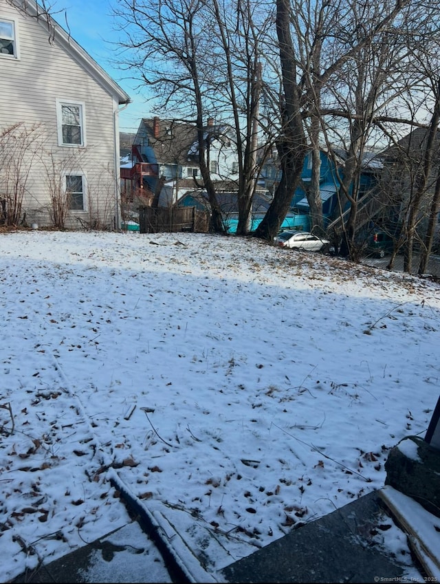 view of yard layered in snow