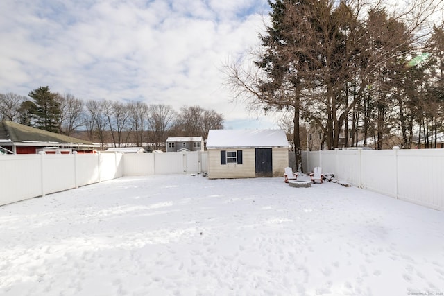 yard covered in snow featuring a shed