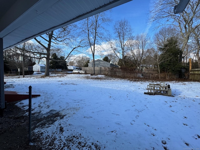 view of yard layered in snow