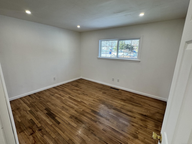 spare room with dark wood-type flooring