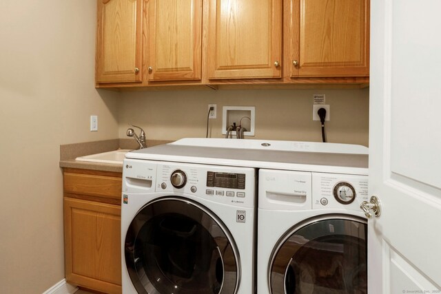 laundry area with cabinets, sink, and washing machine and clothes dryer