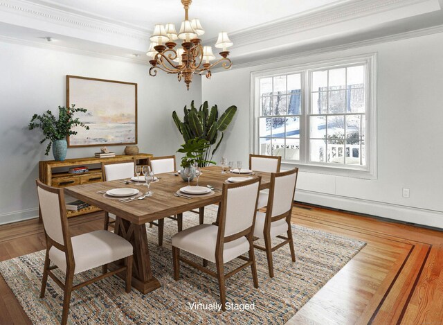 dining area featuring an inviting chandelier, ornamental molding, and wood-type flooring