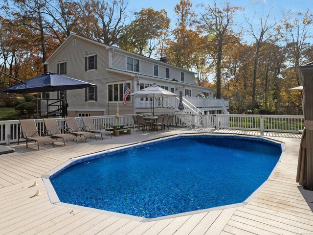 view of swimming pool with a wooden deck