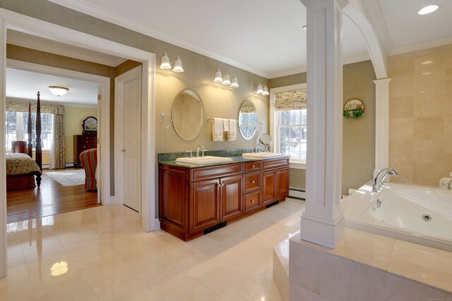 bathroom featuring vanity, crown molding, a relaxing tiled tub, and ornate columns