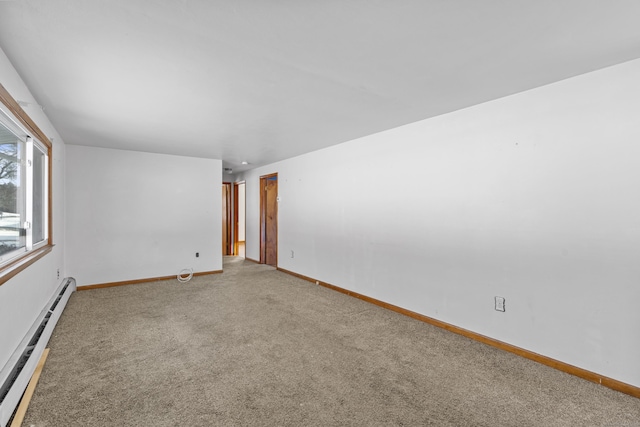 unfurnished room featuring a baseboard radiator and carpet floors