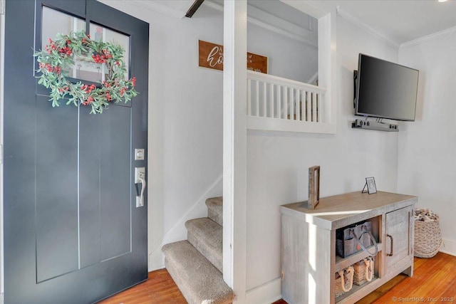 foyer featuring hardwood / wood-style flooring and crown molding