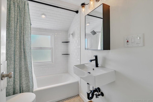 bathroom featuring lofted ceiling, shower / bath combination with curtain, and toilet