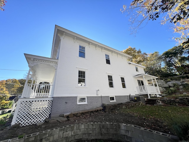 rear view of property with covered porch