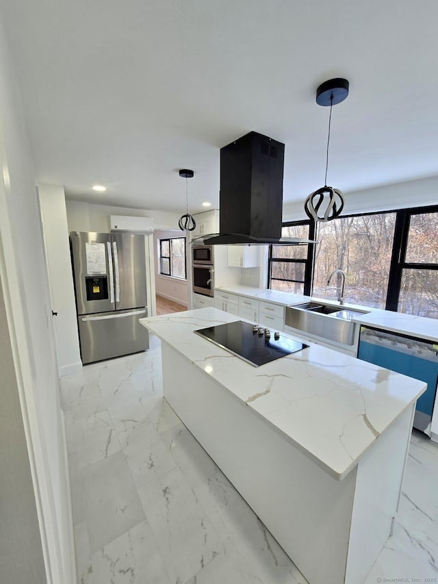 kitchen with light stone counters, appliances with stainless steel finishes, a center island, and hanging light fixtures