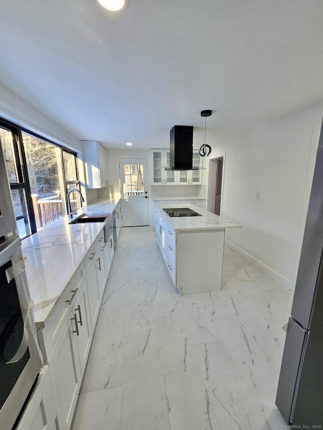 kitchen with pendant lighting, white cabinetry, ventilation hood, a kitchen island, and black electric cooktop