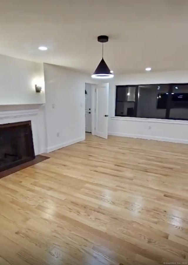 unfurnished living room featuring light hardwood / wood-style flooring