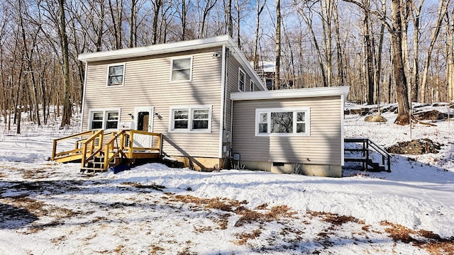 view of snow covered rear of property