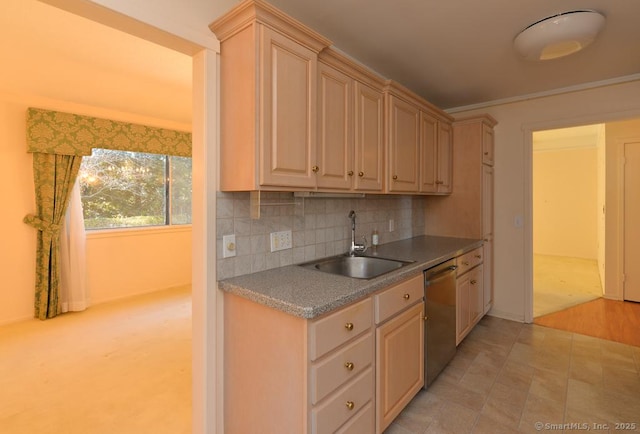 kitchen featuring light brown cabinetry, sink, backsplash, and stainless steel dishwasher