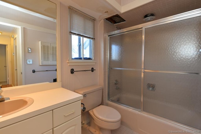 full bathroom featuring vanity, bath / shower combo with glass door, and toilet