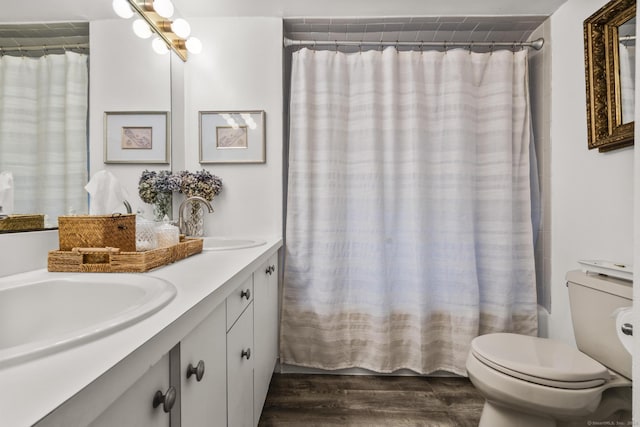 full bathroom with vanity, hardwood / wood-style flooring, shower / bath combo, and toilet