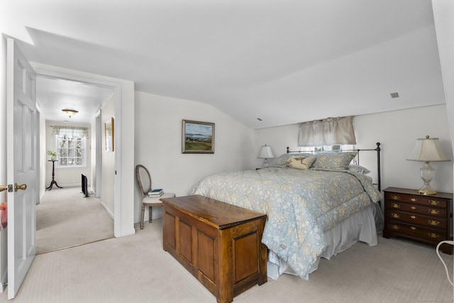 carpeted bedroom featuring lofted ceiling