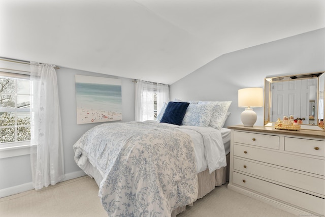 bedroom featuring lofted ceiling and light carpet