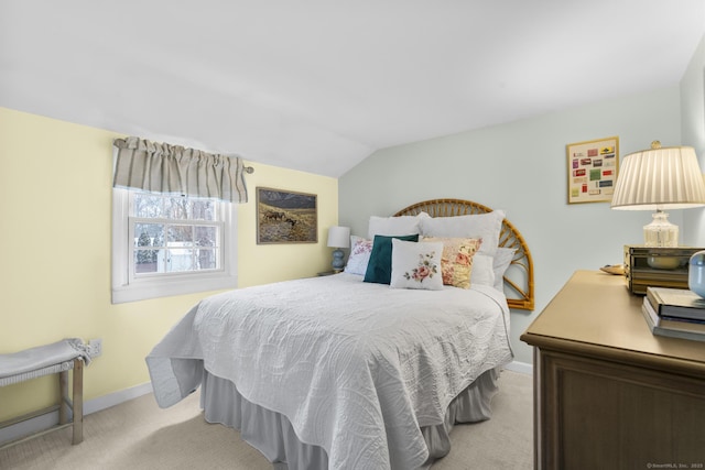 carpeted bedroom featuring lofted ceiling