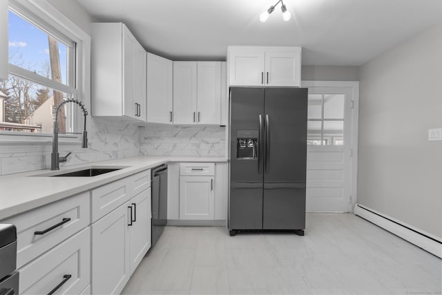 kitchen with a baseboard heating unit, sink, white cabinets, and black appliances