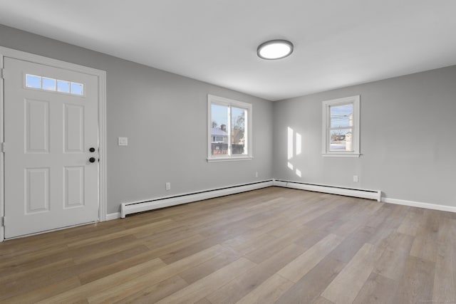 foyer entrance featuring light hardwood / wood-style flooring and baseboard heating