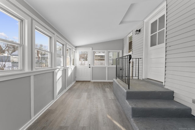 interior space with lofted ceiling and hardwood / wood-style floors